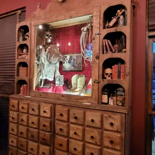 a wooden cabinet with a skeleton display