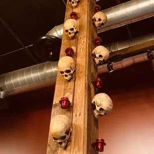 a wooden pole with skulls on it