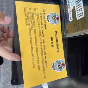 a hand holding a menu