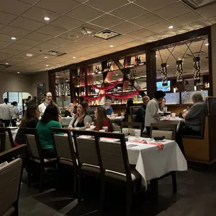 people sitting at tables in a restaurant