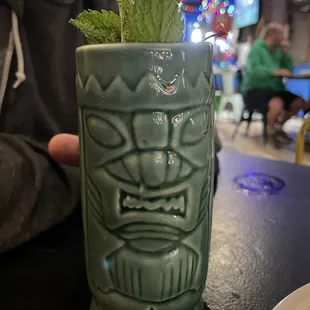 a tiki mug with mint leaves