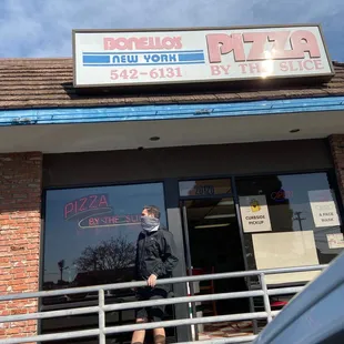 a man walking out of the door