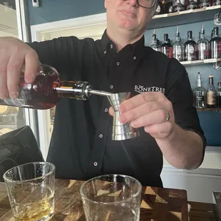 a bartender pouring a drink
