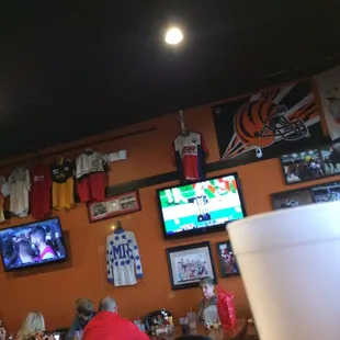 a man sitting at a table in front of a television