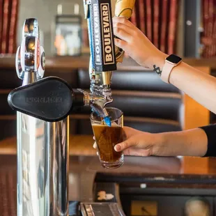 a person pouring a drink