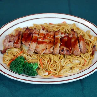 a plate of noodles with meat and broccoli