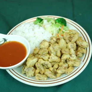a plate of food with rice and broccoli