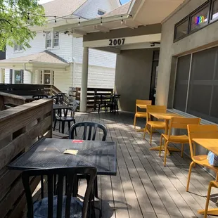 a patio with tables and chairs