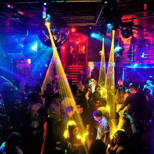 a crowd of people dancing at a nightclub