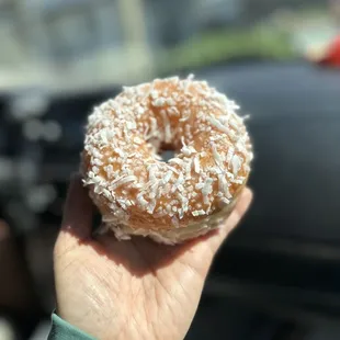 a hand holding a donut