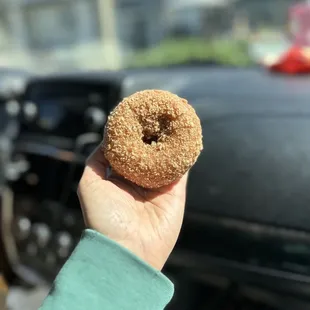 a hand holding a donut