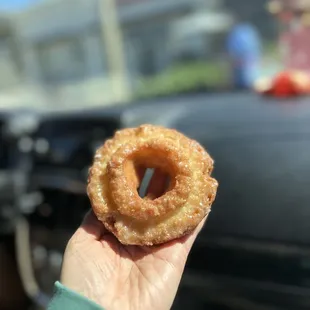 a hand holding a donut