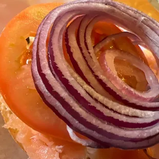 a sandwich with onion and tomato