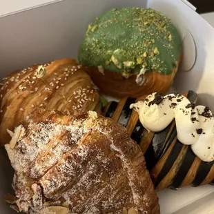 salmon lox croissant sandwich, pistachio filled pastry, cookies and cream filled croissant, almond croissant