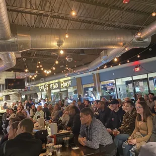 a crowd of people sitting at tables