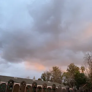 a cloudy sky over a row of toilets