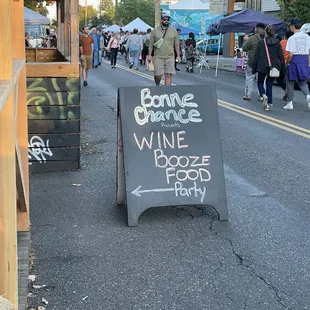 a man standing next to a sign