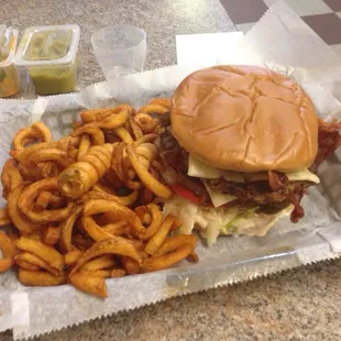Double spicy cheeseburger with curly fries.