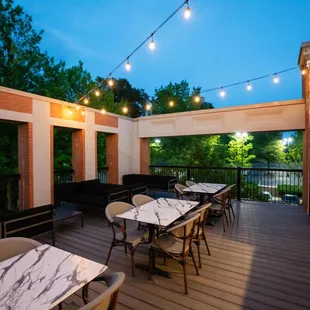 a patio with tables and chairs