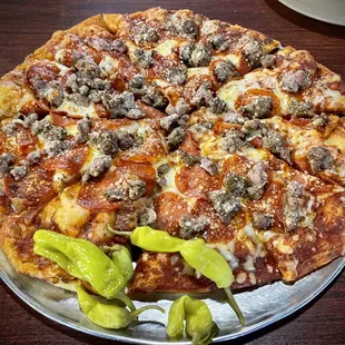 a pizza with sausage and peppers