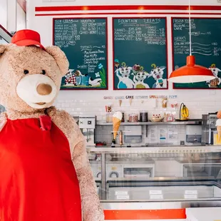 a teddy bear in a red apron