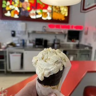 Cookie Dough ice cream in a chocolate dipped waffle cone.