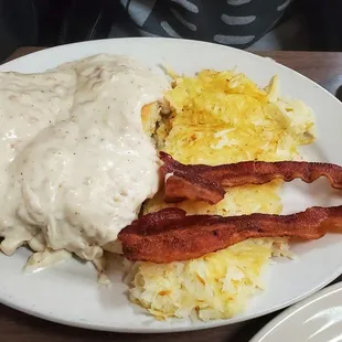 Full biscuits and gravy, eggs on a separate plate.