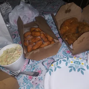 two boxes of fried chicken and a bowl of coleslaw