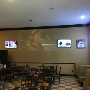 a woman on a screen in a restaurant