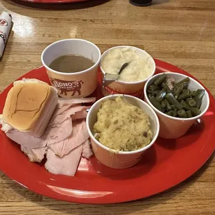Turkey, stuffing, green beans, mashed potatoes, gravy, and a roll of