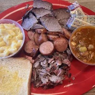 Three meat combo: brisket, sausage and pulled pork. Sides: Mac n cheese and Brunswick Stew.