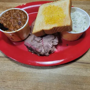 Brisket baked beans potato salad and garlic toast .