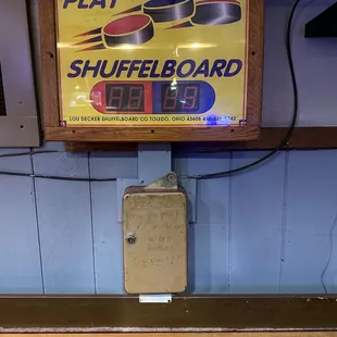 a sign for a shuffleboard game