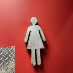 ows a female restroom sign