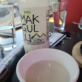 a bowl of water and a bottle of sake