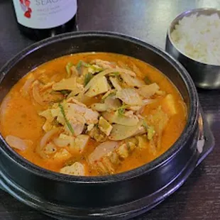 a bowl of stew and a glass of wine