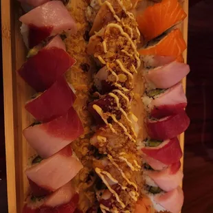 a variety of sushi on a wooden platter