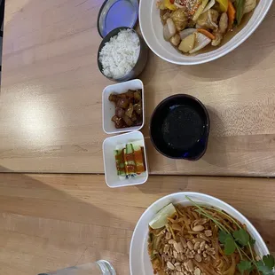 a wooden table with bowls of food on it
