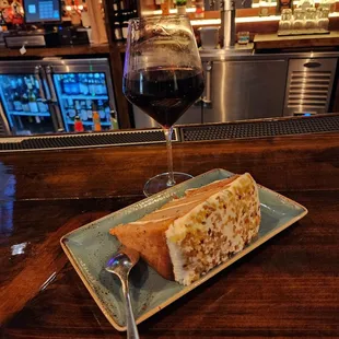 a sandwich and a glass of wine