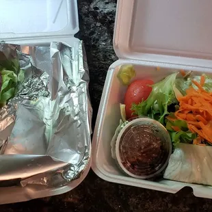 Lamb gyro (without tatziki sauce) with Greek salad for take out. Delicious lamb and salad.