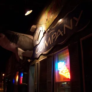 a shark hanging from the side of a building