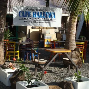 tables and chairs in front of a cafe