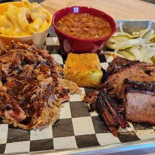 Generous portions of pulled pork, brisket, bbq beans and mac. Cornbread and pickles to top it off.