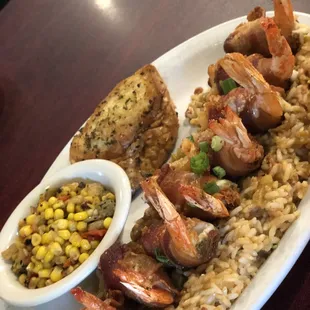 Shrimp en Brochette with dirty rice and roasted corn