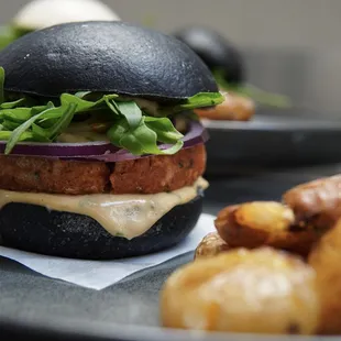 Lentil Miso Burger; A lentil patty lightly fermented with white miso. Including arugula, red onion, dairy-free boochmania remoulade dressing