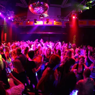 a crowd of people dancing at a nightclub