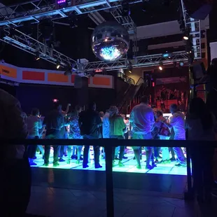 a crowd of people dancing at a disco