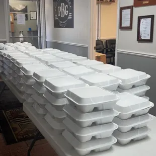 a long table full of trays of food