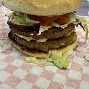 a hamburger on a checkered tablecloth