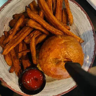 The Green Chili Burger with bun and Sweet potato fries